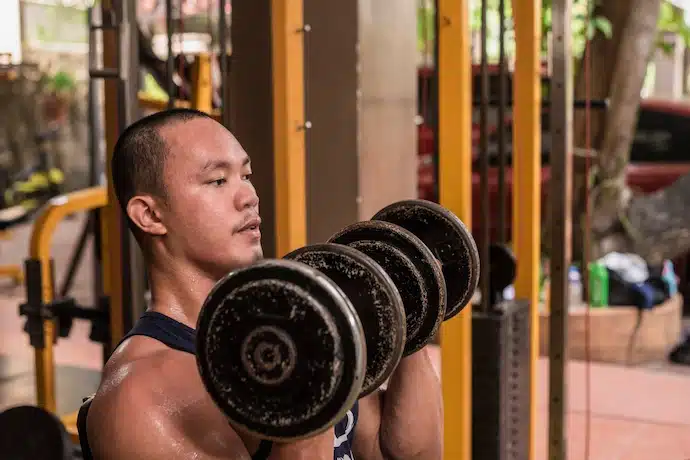 Man doing an Arnold Press