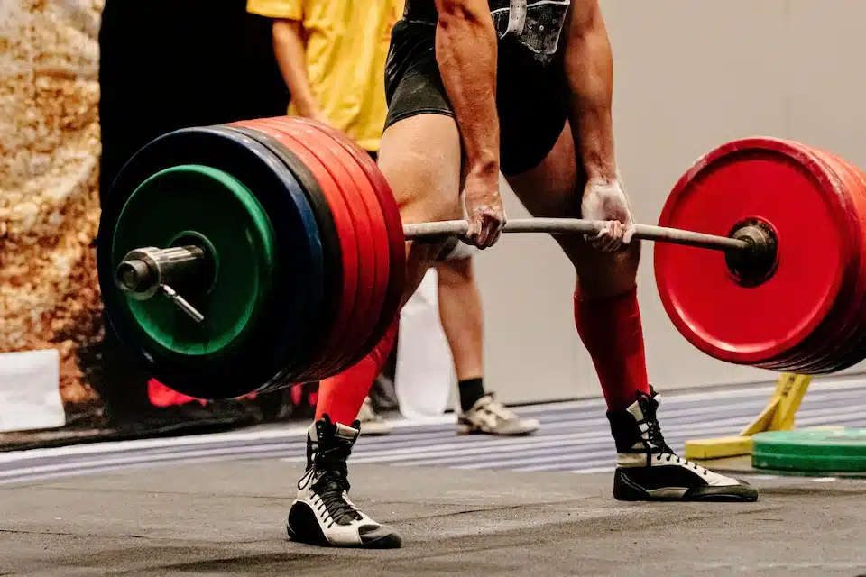 Ma performing a heavy deadlift during a powerlifting meet