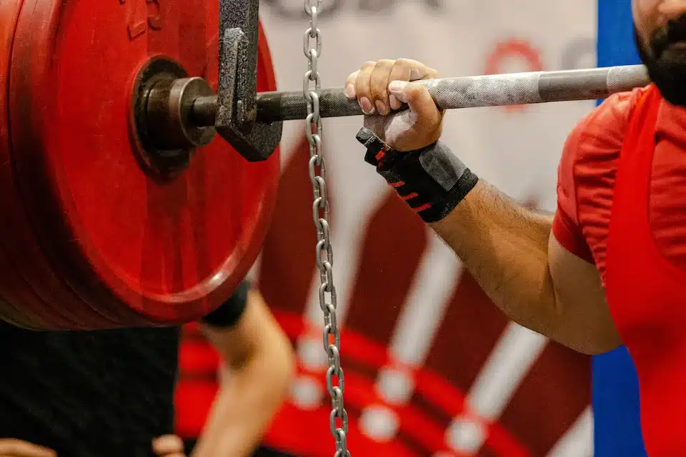 closeup of a man performing a squat during a powerlifting meet