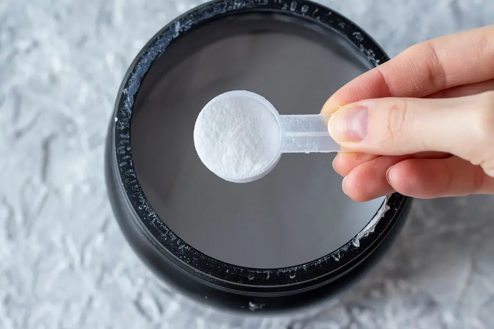 woman scooping creatine