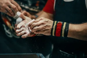 powerlifter chalking up his hands before a lift