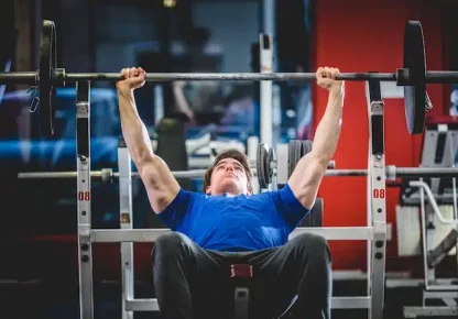 Man performing an incline bench press for upper chest